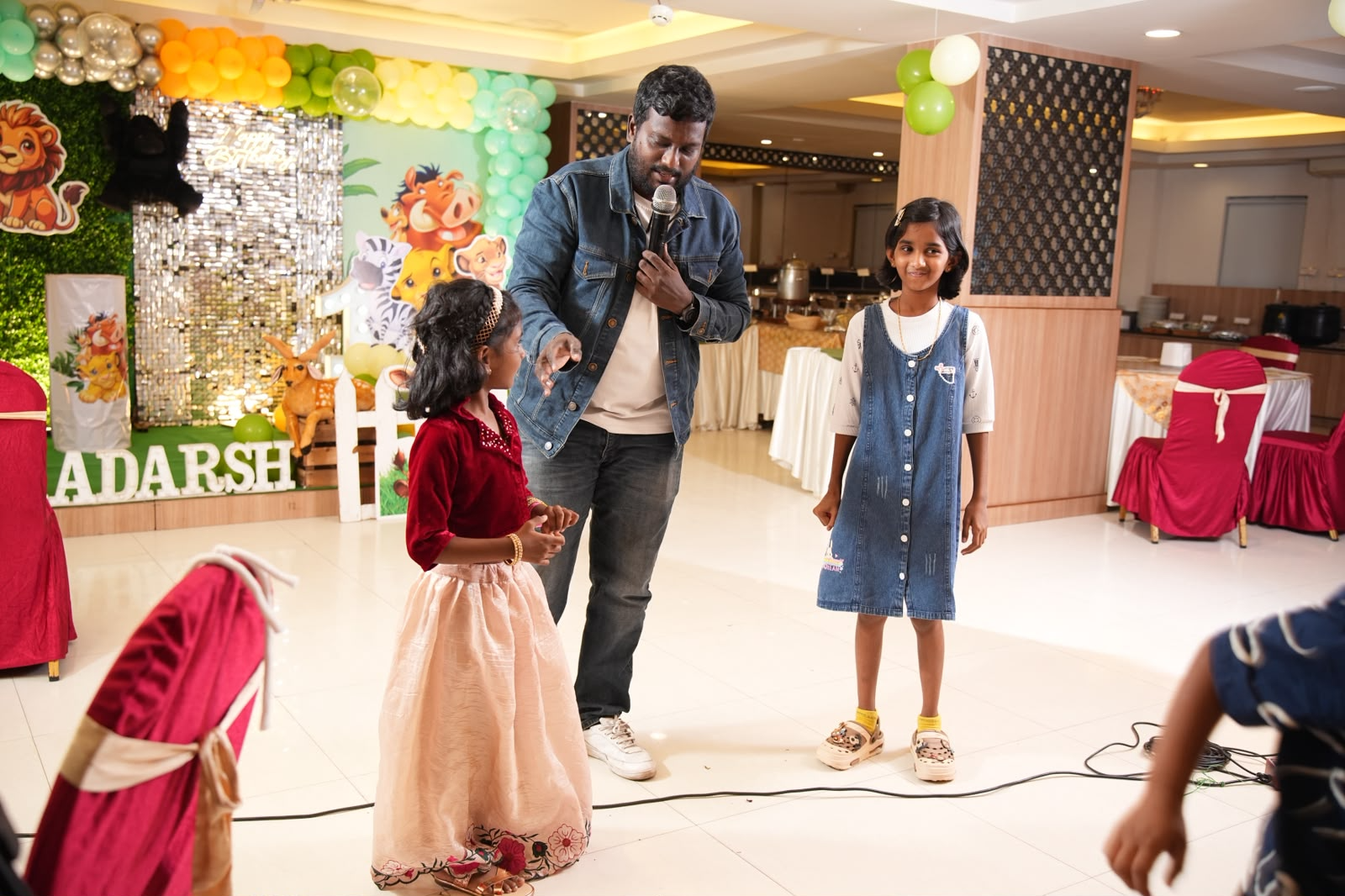 Kalai performing interactive magic for guests at a 1st birthday celebration